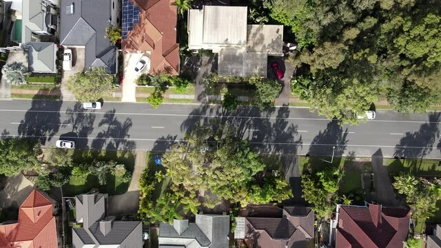 Modern Suburia aerial drone footage over a quiet suburban street road town community summer day 4K High Definition HD b roll relaxing urban video city residential neighborhood scene