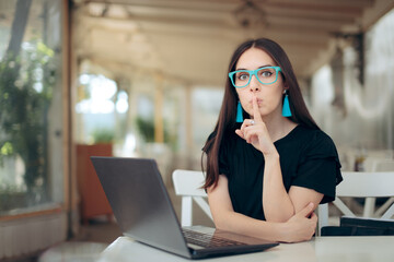 Woman With Finger on the Lips Looking at Laptop