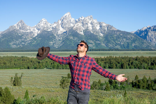 Portrait of young man posing with a view of Grand Tetons in Wyoming, USA