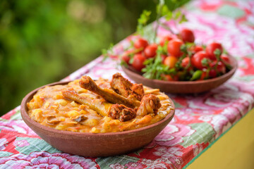 Brazilian cuisine. Poultry hen served in a clay bowl.
