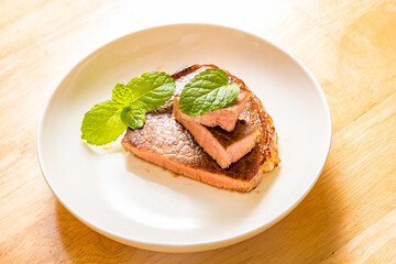 A fine steak dinner on a wood-grain table