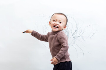 Innocent and lovely children scribble on the white wall