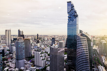 Naklejka premium Bangkok city skyline with skyscrapers at sunset through the mirror window, Cityscape with building in vintage tone