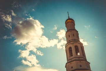Naklejka premium The bell tower building against the blue sky.