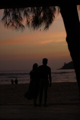 couple on the beach at sunset