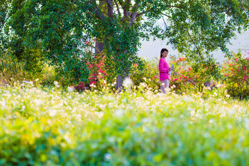 A girl is resting on the grass in the bright sunshine