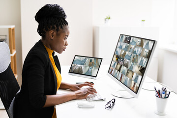 Businesswoman Watching CCTV Footage Of Office Interior