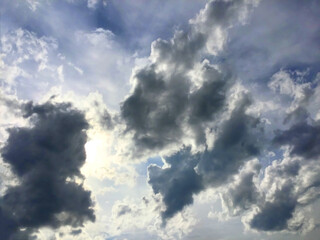 Beautiful cloudy sky. The bright sun above the cumulus clouds