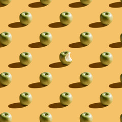 Green apples pattern on yellow background. Wallpaper pattern with apple. Fruit and food theme. Good for wallpaper, textile, background, poster.