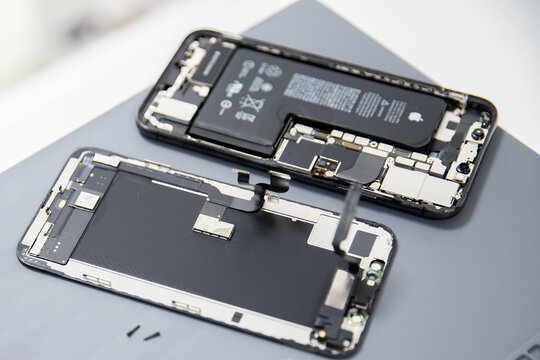 RUSSIA - July 27, 2020: Repair iPhone apple broken phone screen and replace used rechargeable batteries for recycling
