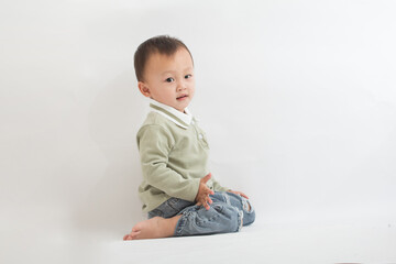 A cute two-year-old boy eats cookies