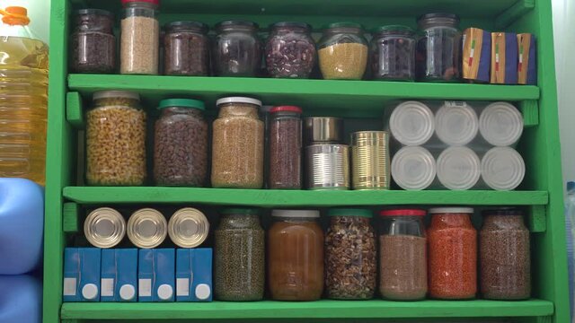 Food Stock Pantry for Any Emergency. Canned, boxed, and shelf-stable items. Long-term storage products on shelves in the home pantry