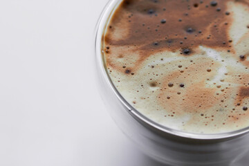 cappuccino coffee in a glass coffee cup with foam
