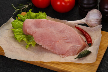 Raw Turkey steak served rosemary