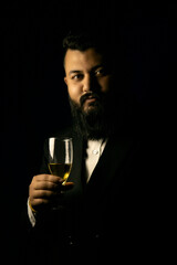 Business man with long beard and campaign glass in black suit