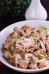 crispy pork belly in savory mayonnaise with fresh red onions and green chilli