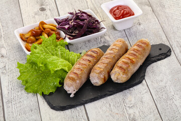 Grilled sausages served mushrooms and cabbage