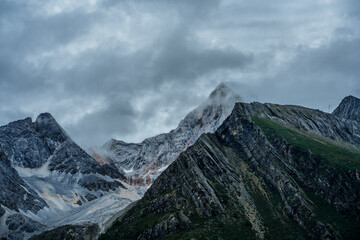 The snow mountains in Yading, Sichuan, China, summer time, on a cloudy day.