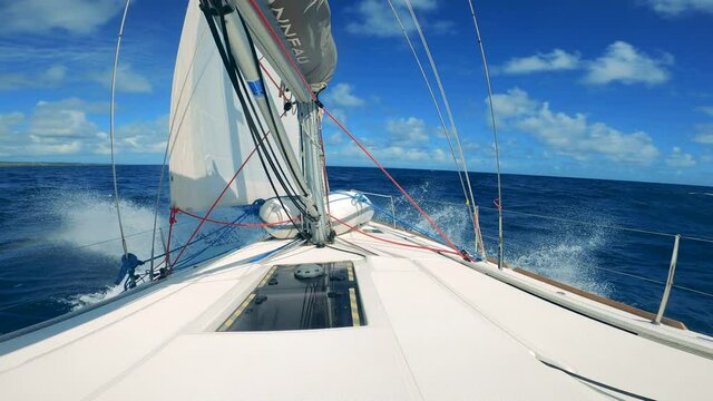 Blue ocean waters are yacht's prow floating along them