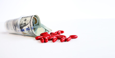 Health insurance, business concept. Red and blue pills on white background next to a wad of cash.pills and money isolated on a white background