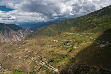 The road from Sichuan to Tibet, bends over on mountains, on a cloudy day.