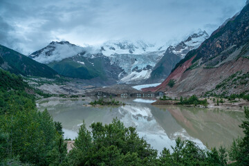 Midui Glacier, a big glacier on mountains in Tibet, China, on summer time, on a cloudy day.