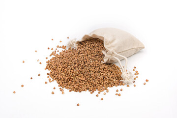 Raw buckwheat in a linen or jute bag on a white background