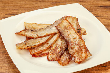 Roasted juicy bacon in the plate