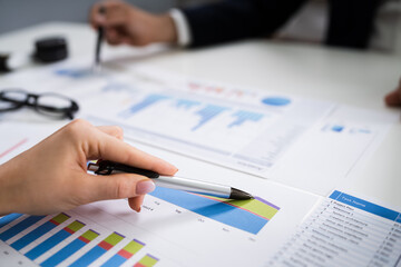 Financial Advisor Looking At Growth Progress Chart