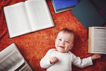 One year old baby with spectackles and books