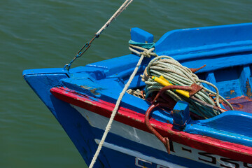 Fototapeta na wymiar bow of a fishing boat with an anchor and ropes in Tavira, Portugal