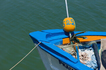 bow of a fishing boat with an anchor and ropes in Tavira, Portugal