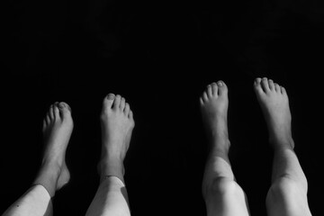 Abstract top view. Feet in the water
