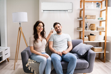 Happy Woman Holding Air Conditioner Remote