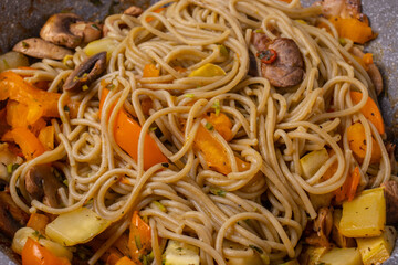 tasty cooked hot spaghetti with yellow sweet peper,tomatoes and mushrooms