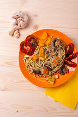 tasty cooked hot spaghetti with yellow sweet peper,tomatoes and mushrooms