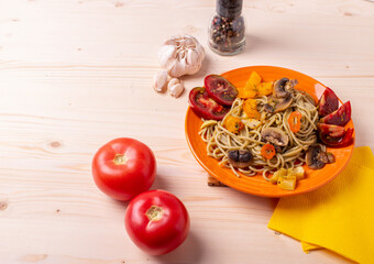 tasty cooked hot spaghetti with yellow sweet peper,tomatoes and mushrooms