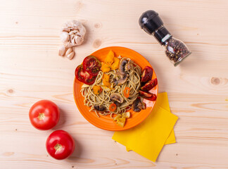 tasty cooked hot spaghetti with yellow sweet peper,tomatoes and mushrooms