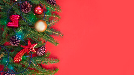 Christmas background with xmas tree on red canvas background. Merry christmas card. Winter holiday theme. Happy New Year. Space for text. christmas backdrop top view. Flat lay.