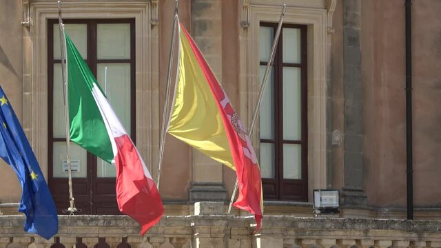Sicily, Noto town the Baroque Wonder - UNESCO Heritage Site. Sicilian flag on Palazzo Ducezio. Footage 4k