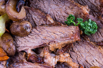 delicious roast beef with roasted potato, carrots, celery and shiitake mushroom