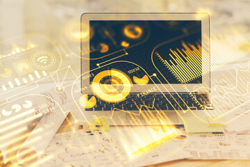 Computer on desktop in office with technology theme hologram. Multi exposure. Tech concept.