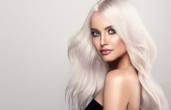  Beautiful girls with hair coloring in blond. Straight and smooth hair coloring in ultra blond color in a beauty salon. Beauty, cosmetics and makeup