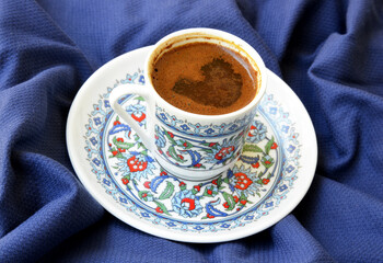 a cup of Turkish coffee on fabric background