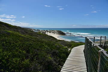 A boardwalk path takes you to the beauty of the blue sea and white beaches in De Hoop Nature Reserve, Western Cape, South Africa