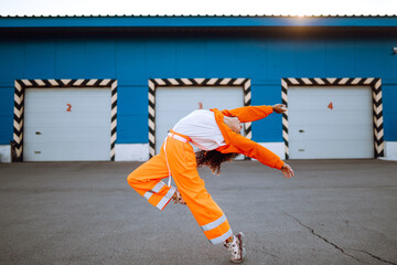 African American girl - dancer dancing in the street at sunset. Sport, dancing and urban culture concept. Fashion lifestyle.