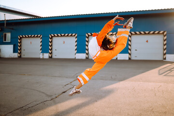 African American girl - dancer dancing in the street at sunset. Sport, dancing and urban culture concept. Fashion lifestyle.