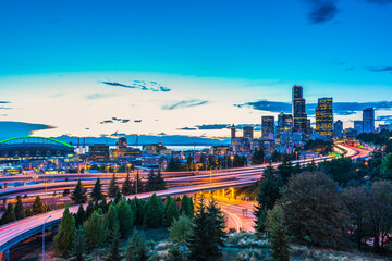 Seattle skylines and Interstate freeways converge at sunset, Seattle, Washington, USA.