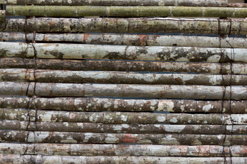 long old wooden logs folded horizontally close-up