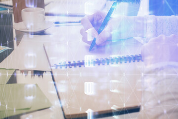 Double exposure of writing hand on background with data solution technology hologram. Ai concept.